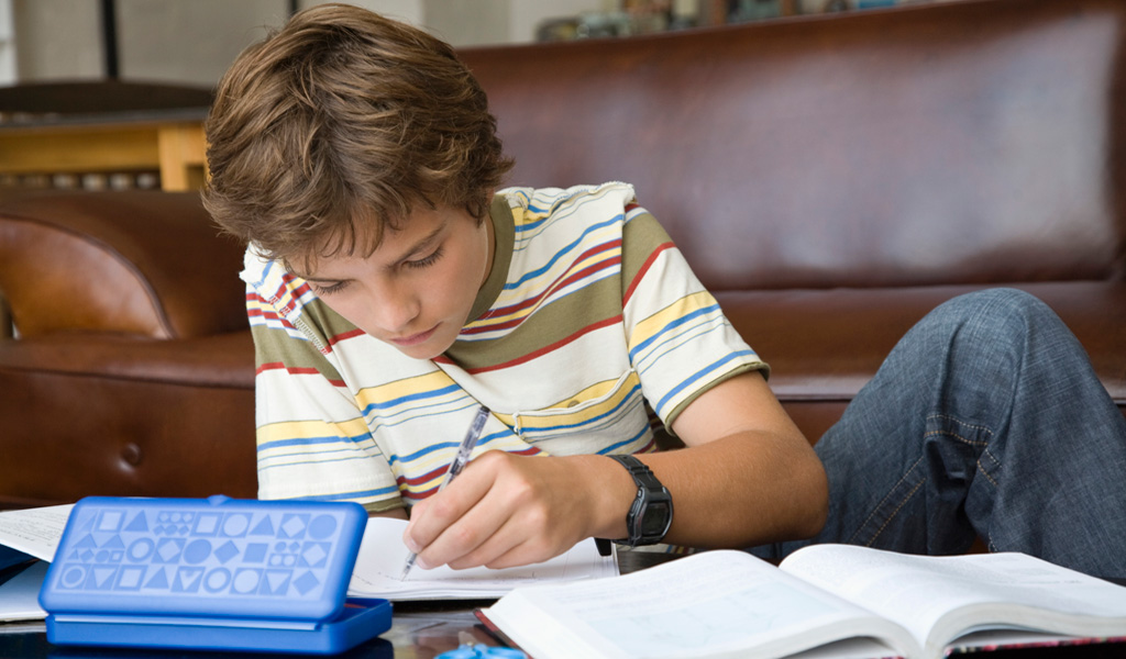 School.Homework.Homework help a system that works for ADHD children.Article.1034.boy homework home.ts 86495572-3