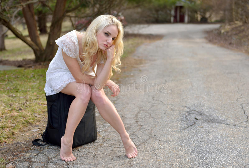 beautiful-young-woman-waiting-road-ride-stunning-caucasian-white-sundress-sitting-suitcase-bag-barefoot-41852083