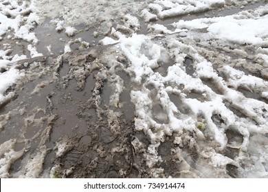 dirty-road-foot-prints-on-260nw-734914474