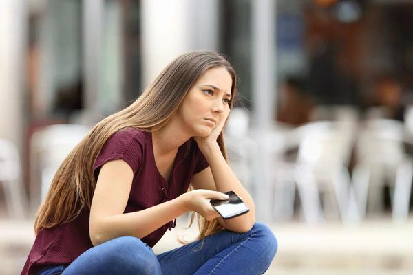 sad-girl-waiting-mobile-phone-600nw-524194495